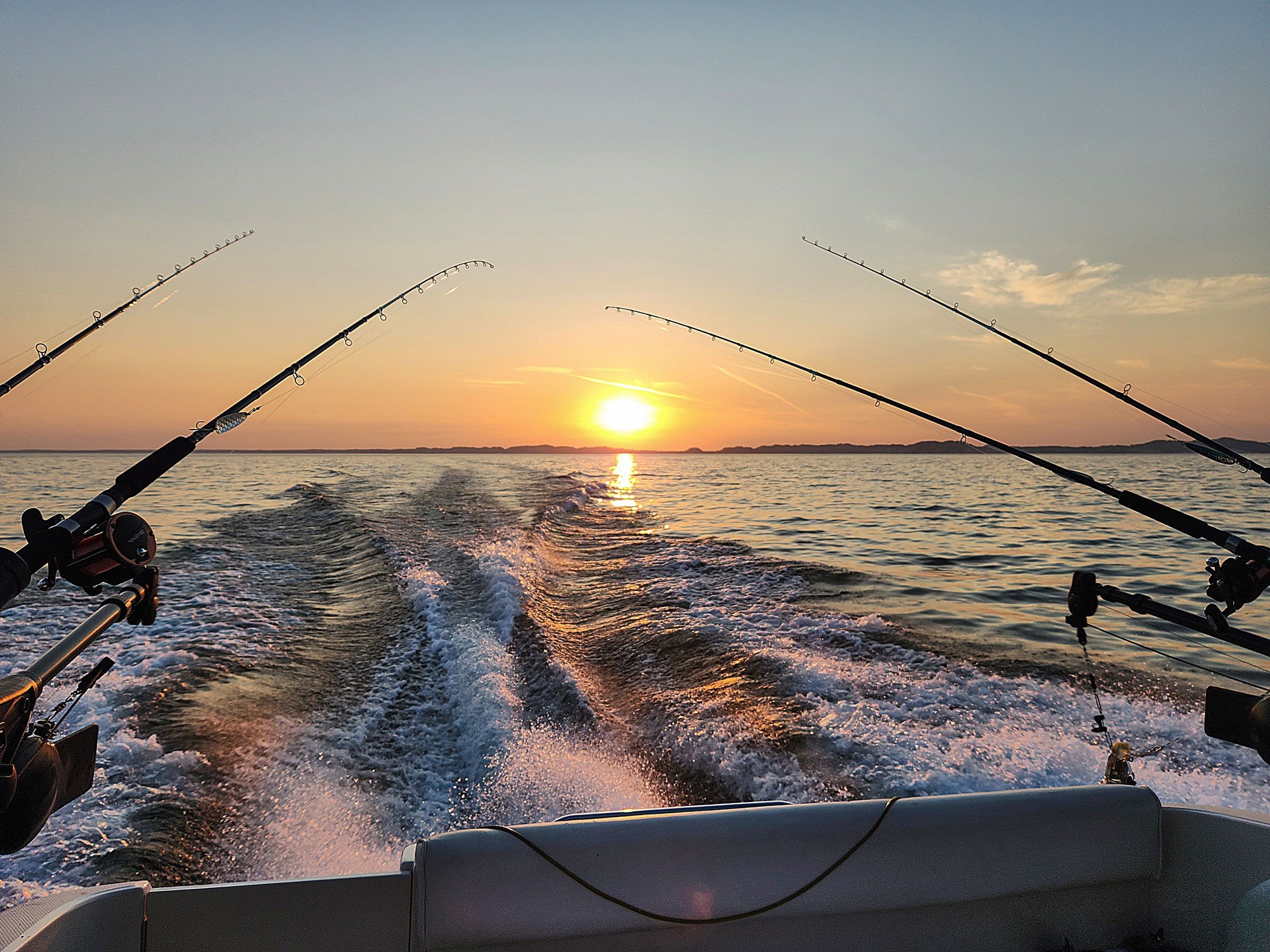 Fishing Poles on Boat with Sunrise Sky